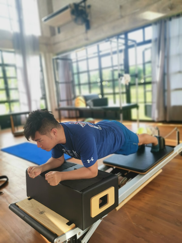 Man does Pilates on Reformer 